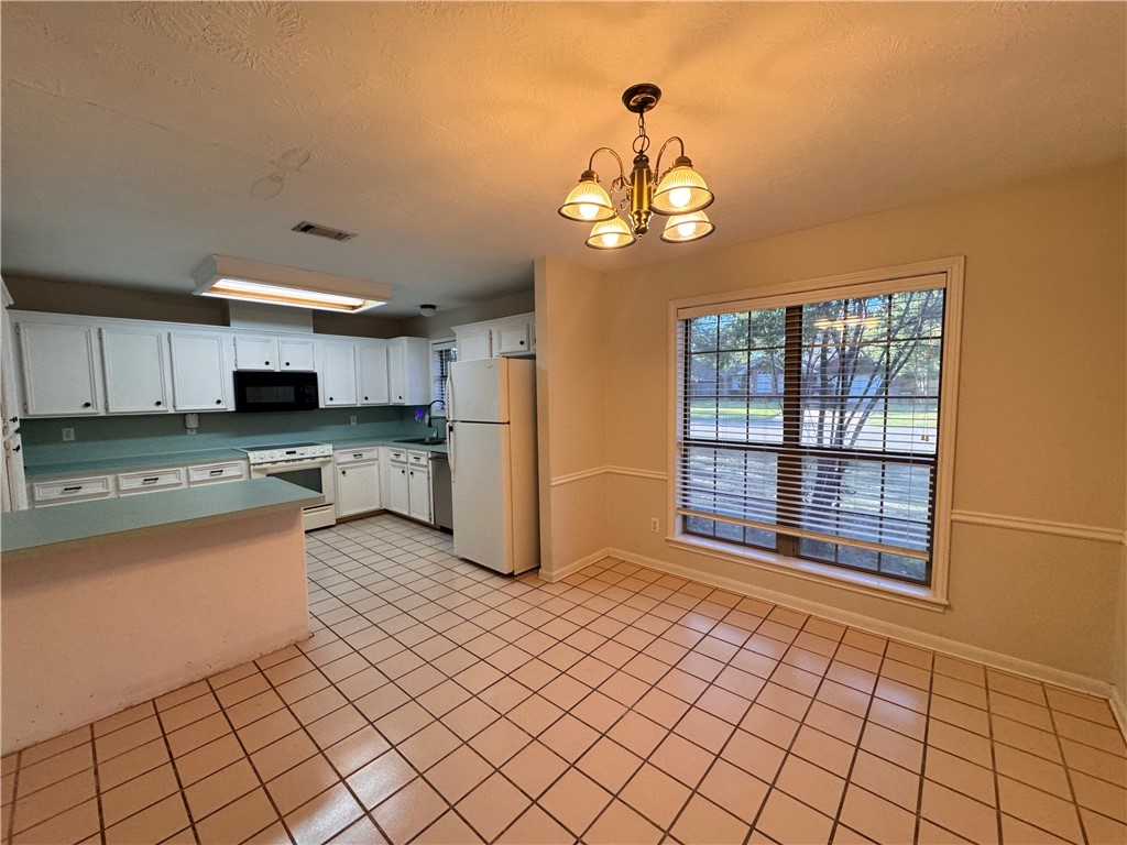 1204 Bayou Woods Drive College Station, TX 77840 - Photo 5 of 14 a view of a kitchen with a sink and dishwasher kitchen view