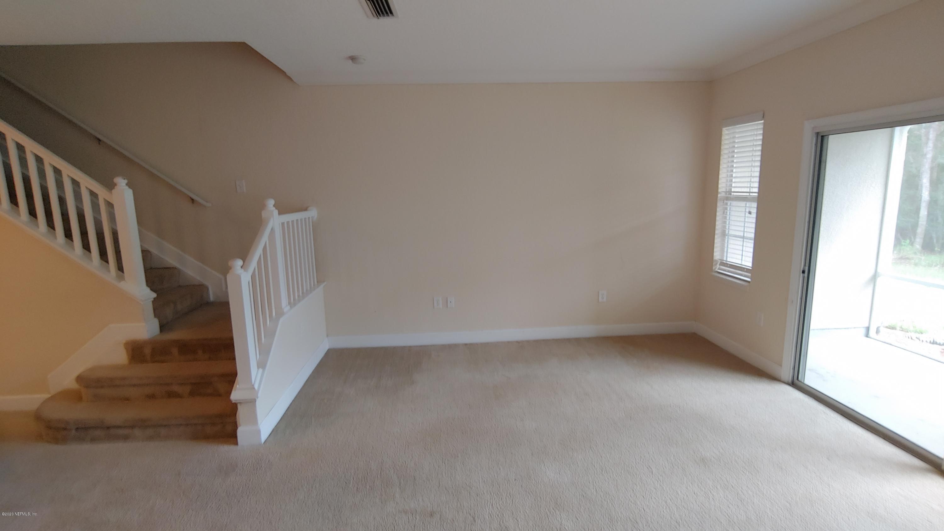 a view of an empty room with stairs