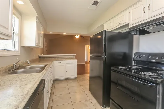a kitchen with a sink stove and refrigerator