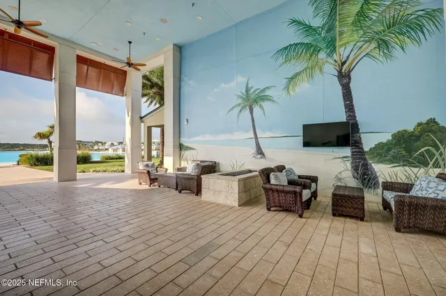 a living room with lots of furniture and view of kitchen
