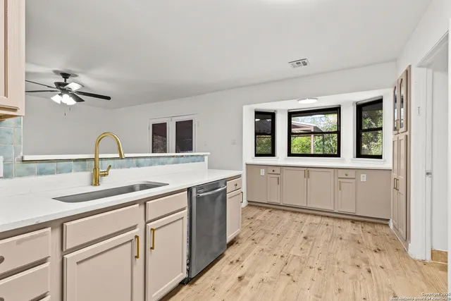 a kitchen with a refrigerator and a stove top oven