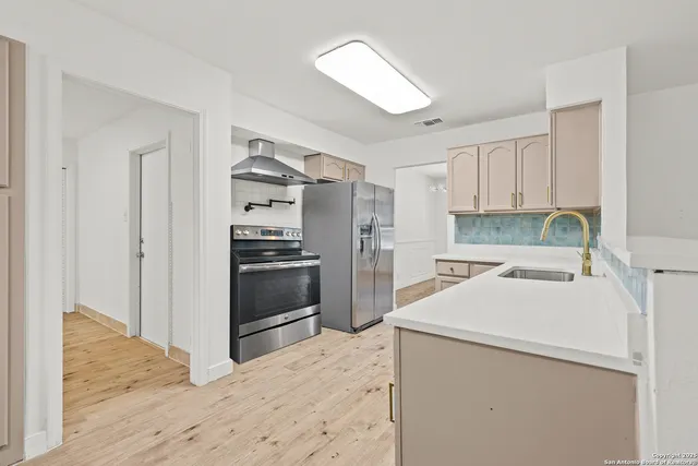 a bathroom with a bathtub shower sink vanity mirror and toilet