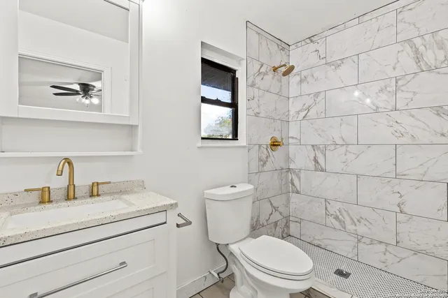 a front view of a house with a garden and yard