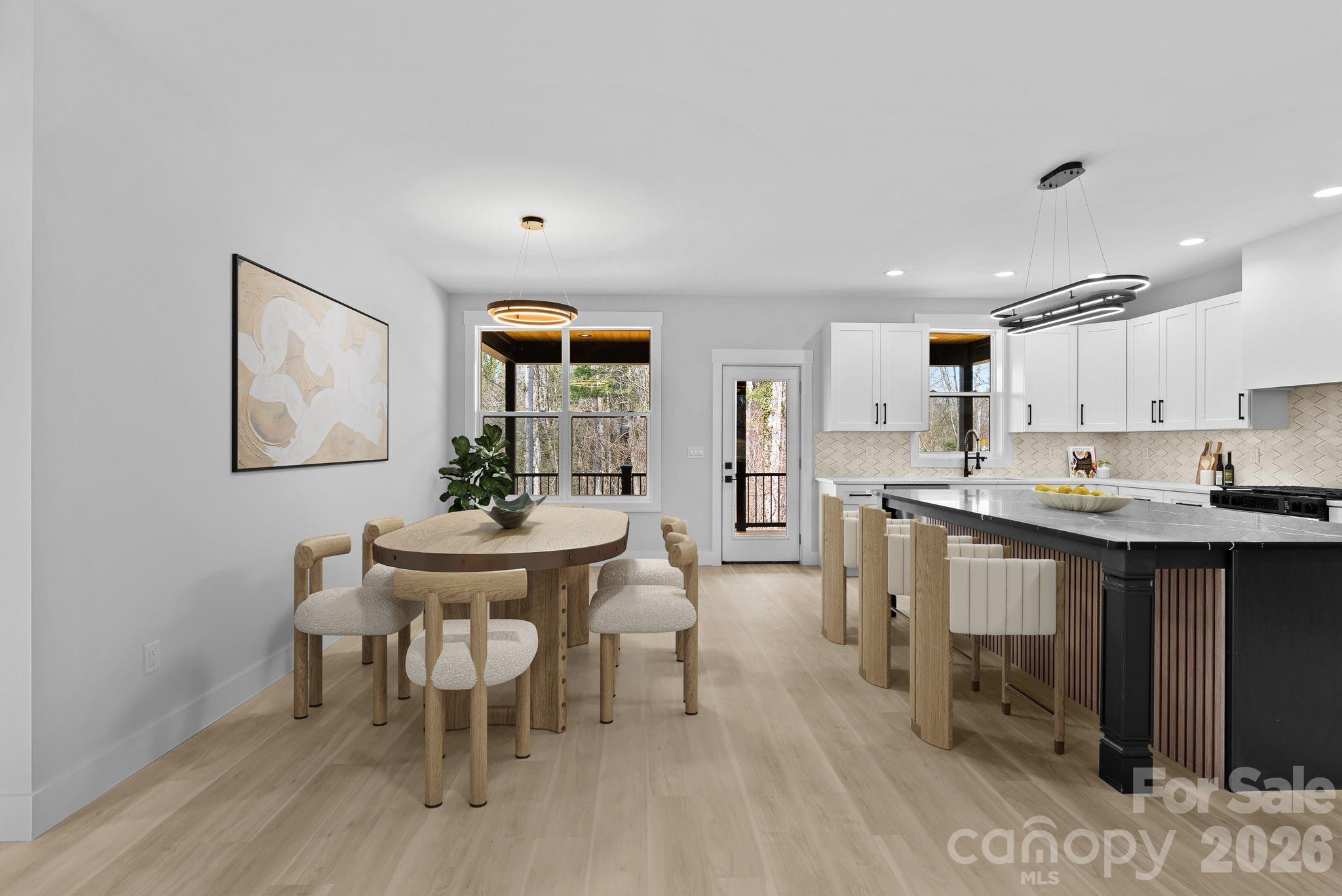 19 East Starnes Cove Road Asheville, NC 28806 - Photo 12 of 46 a view of a dining room with furniture and wooden floor