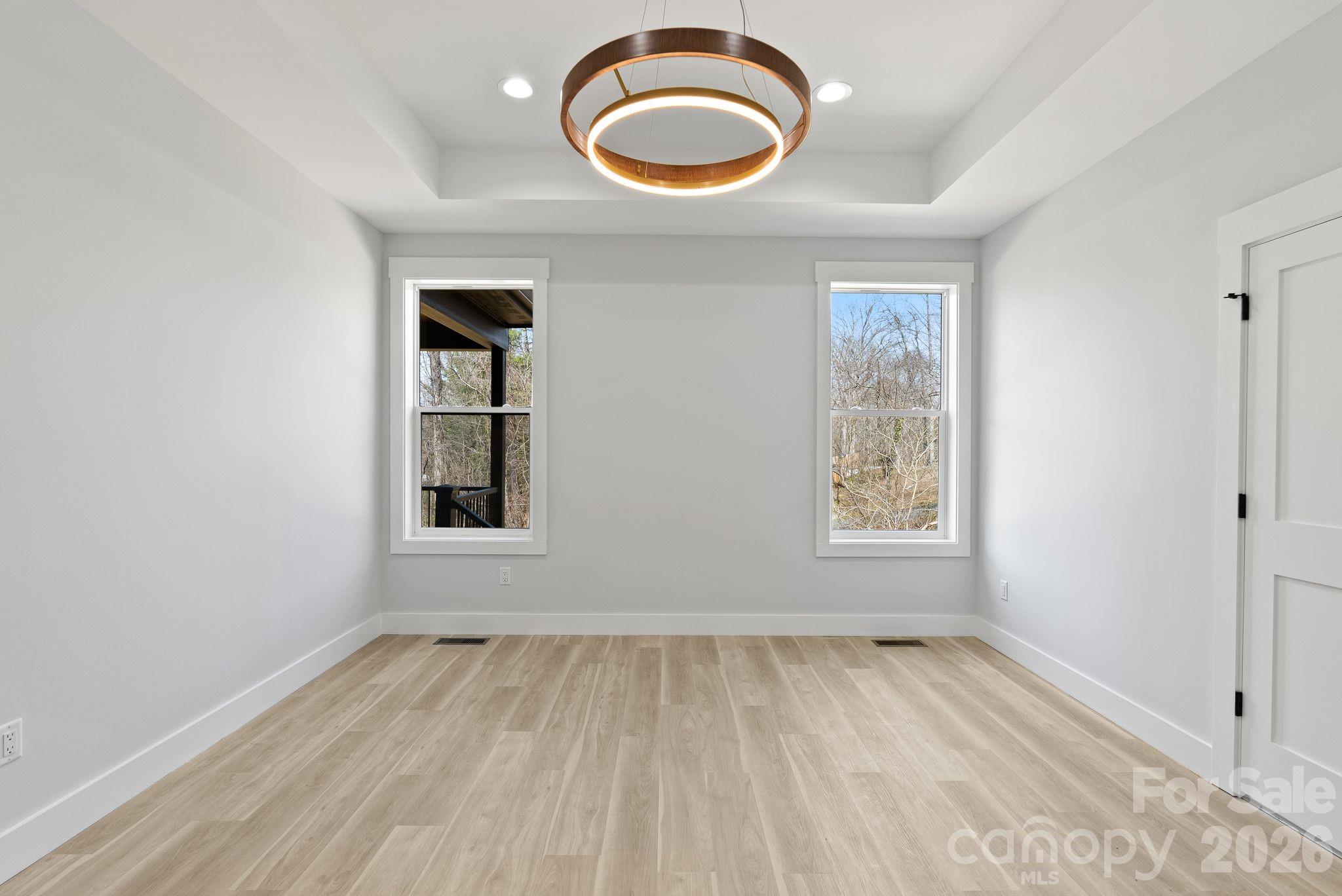 19 East Starnes Cove Road Asheville, NC 28806 - Photo 19 of 46 wooden floor in an empty room with a window