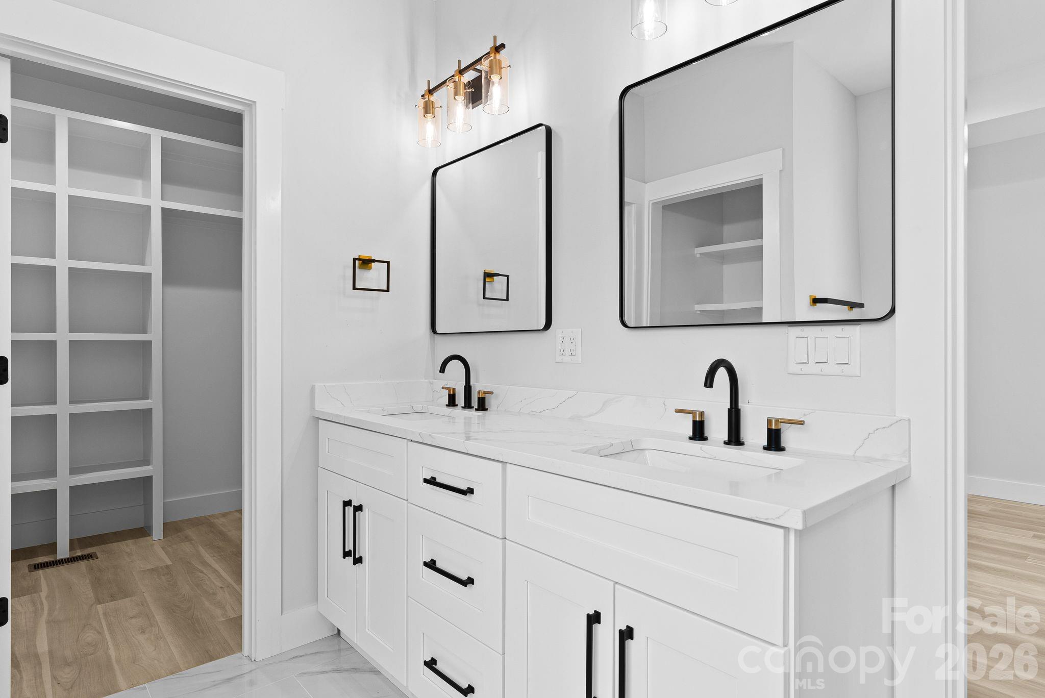 19 East Starnes Cove Road Asheville, NC 28806 - Photo 20 of 46 a bathroom with double sink and a mirror