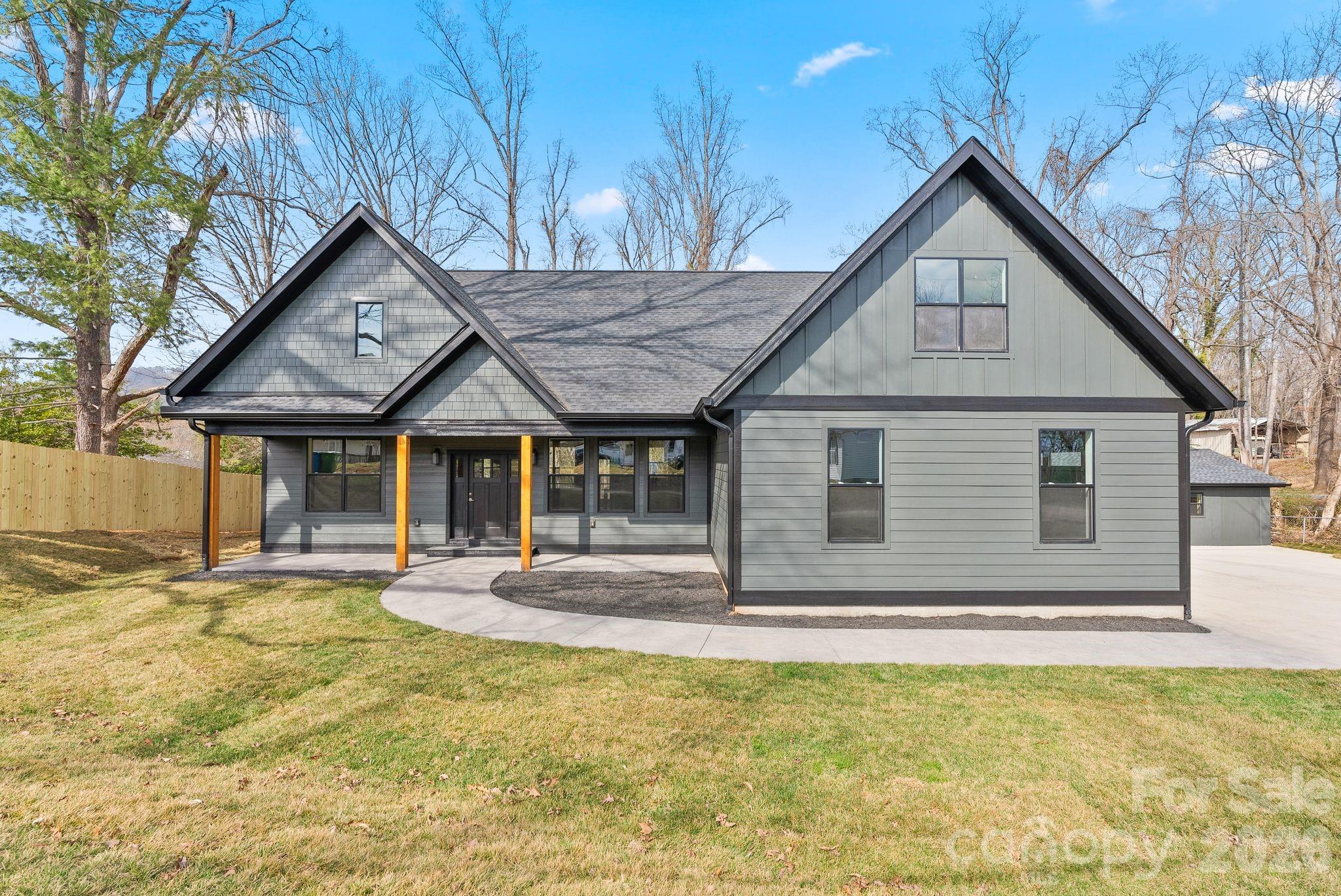 19 East Starnes Cove Road Asheville, NC 28806 - Photo 2 of 46 a front view of a house with a yard