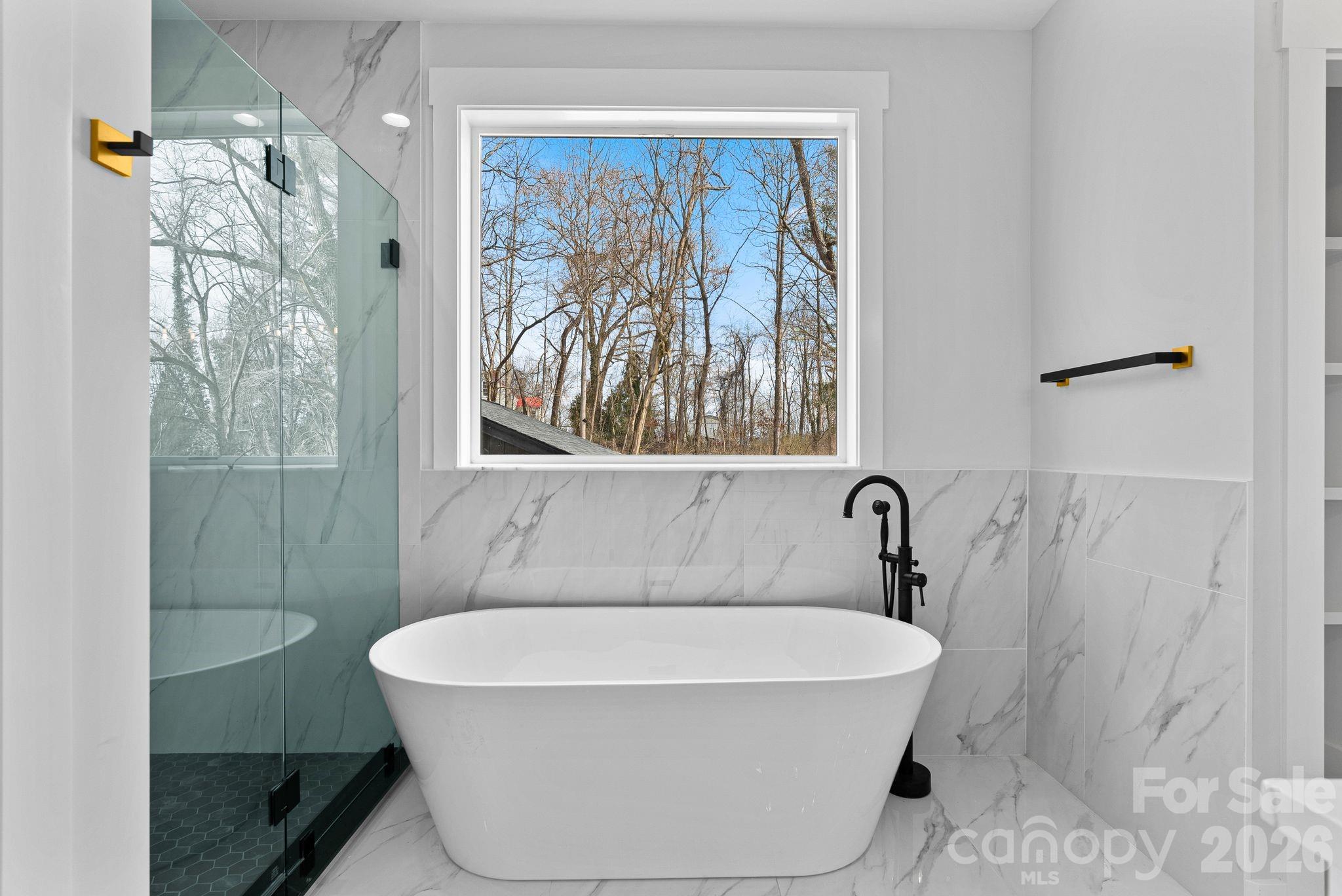 19 East Starnes Cove Road Asheville, NC 28806 - Photo 21 of 46 a bathroom with a bathtub and shower