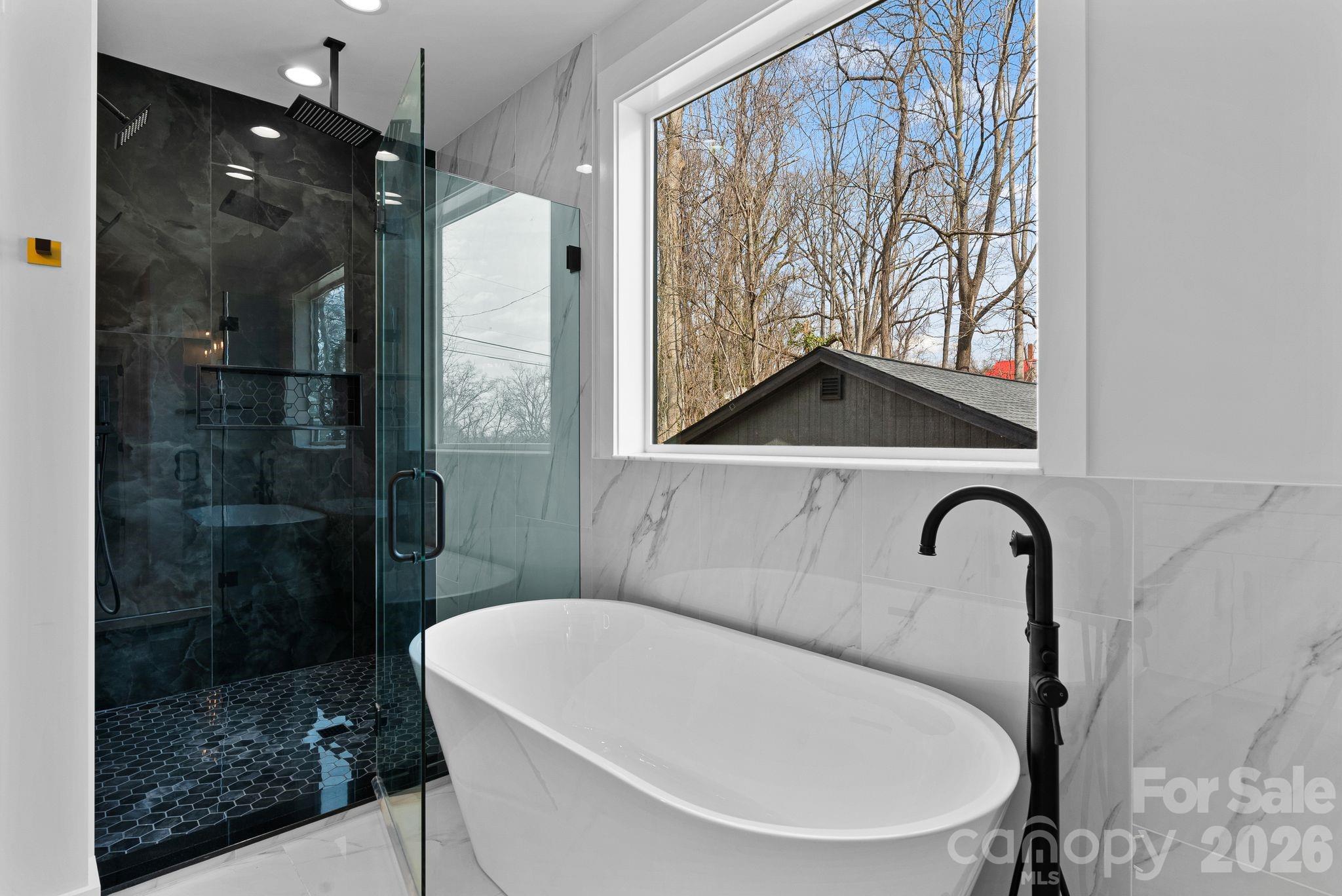 19 East Starnes Cove Road Asheville, NC 28806 - Photo 22 of 46 a bathroom with a bathtub and a shower