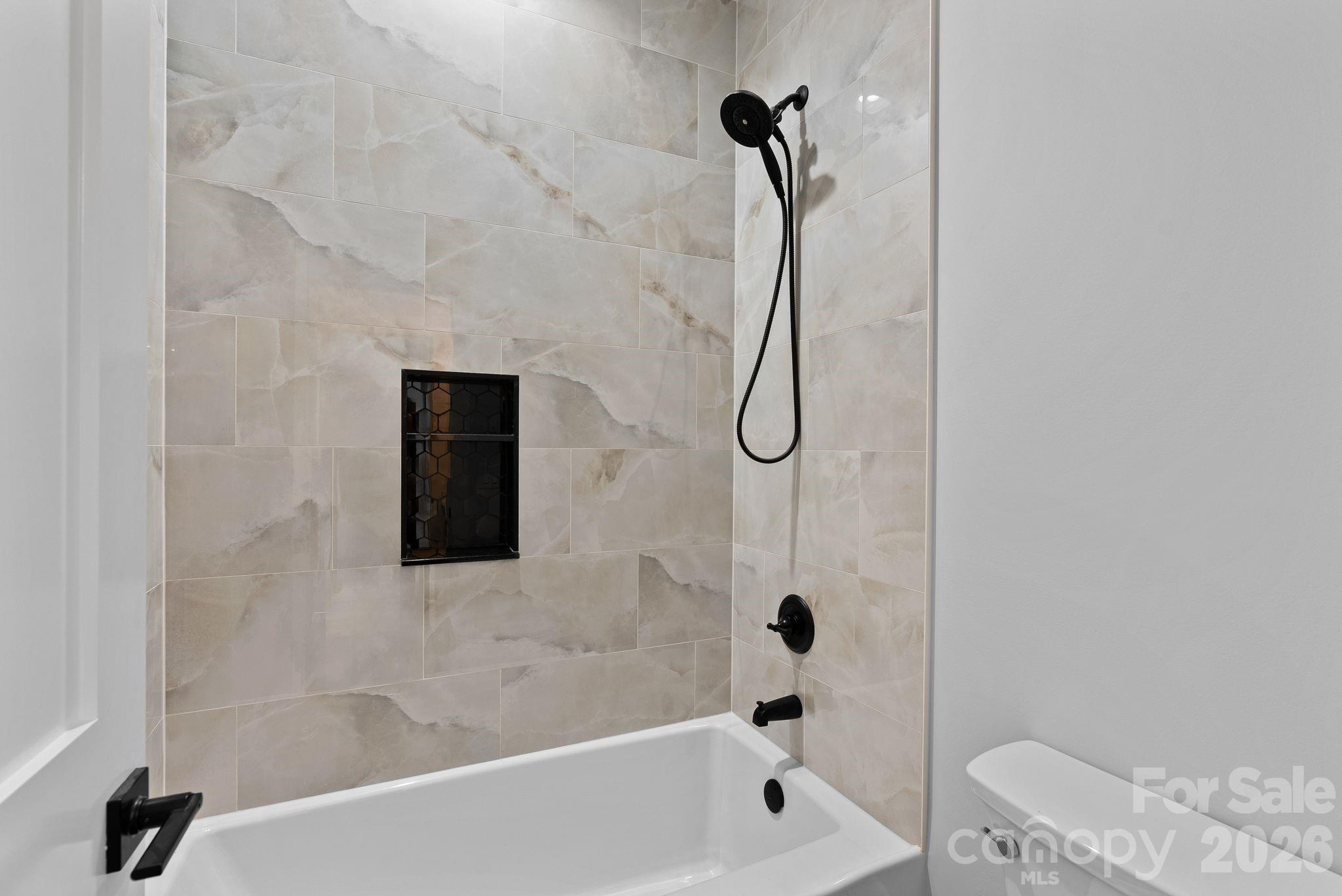 19 East Starnes Cove Road Asheville, NC 28806 - Photo 28 of 46 a bathroom with a shower and a bathtub