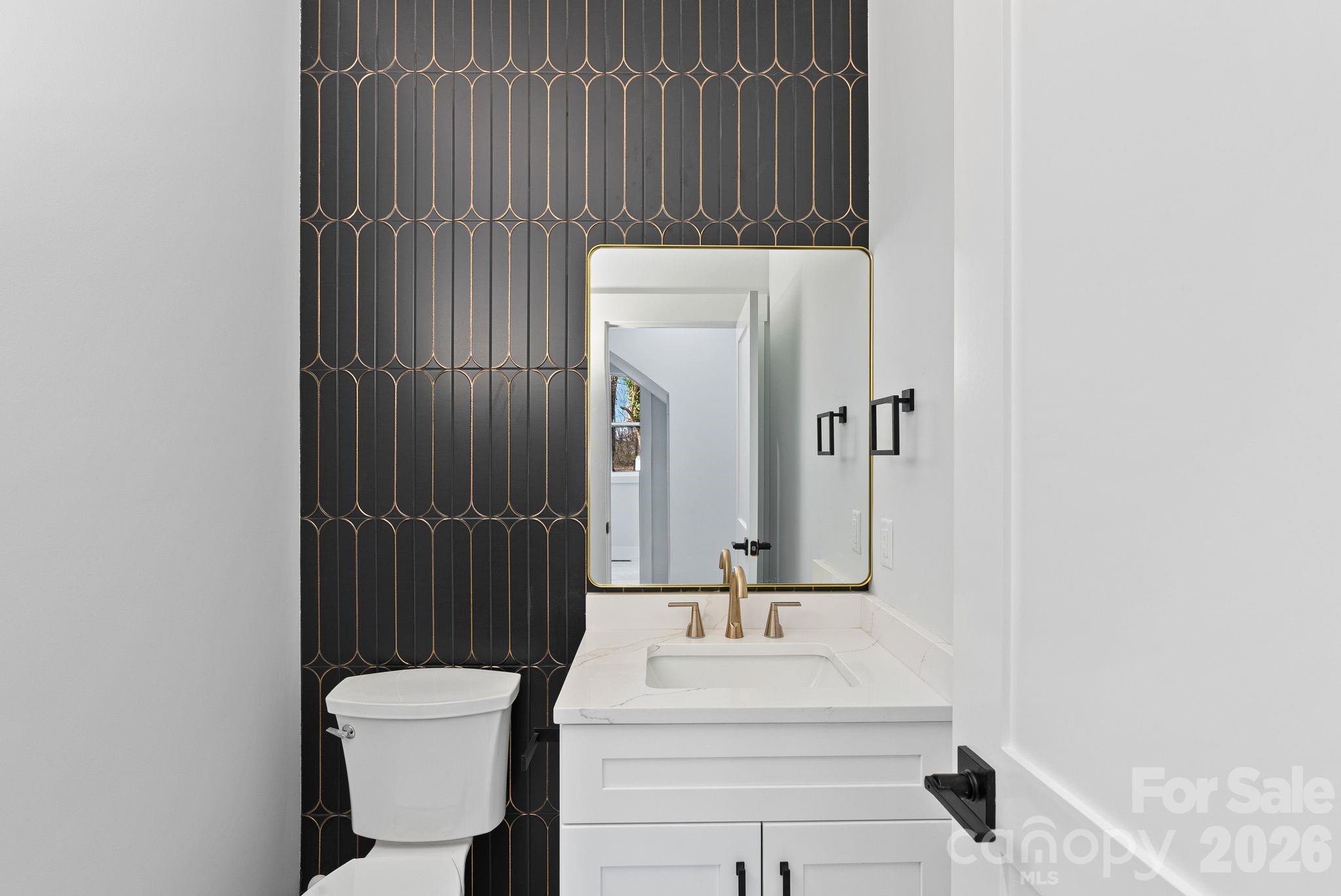 19 East Starnes Cove Road Asheville, NC 28806 - Photo 31 of 46 a bathroom with a sink toilet and mirror