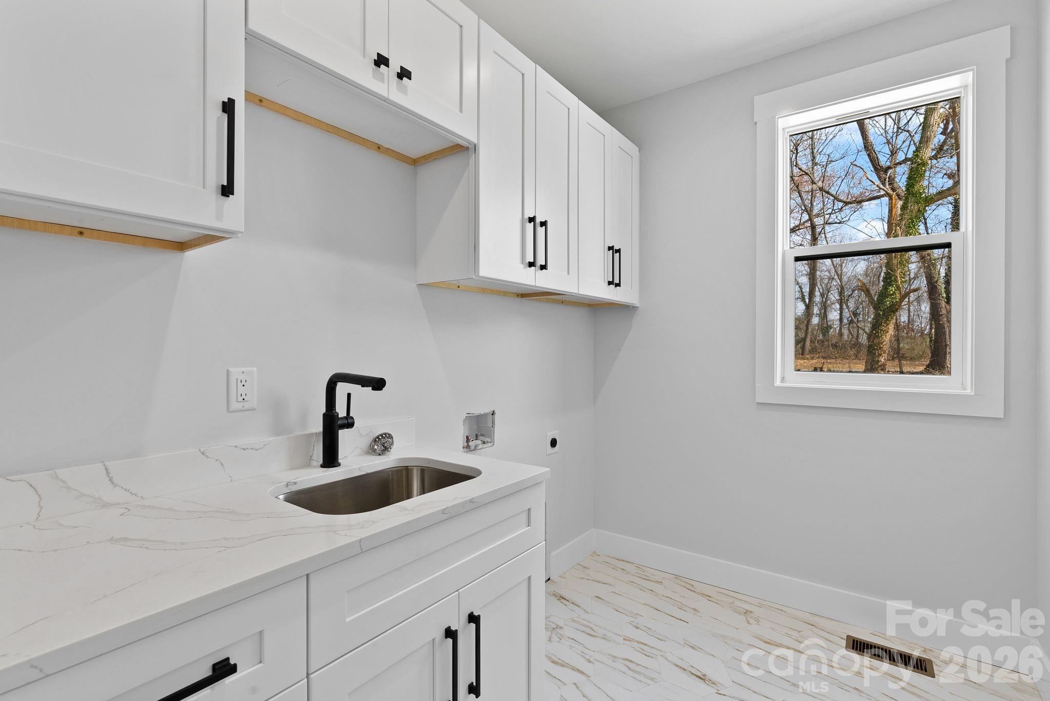 19 East Starnes Cove Road Asheville, NC 28806 - Photo 32 of 46 a kitchen with stainless steel appliances a sink a window and cabinets