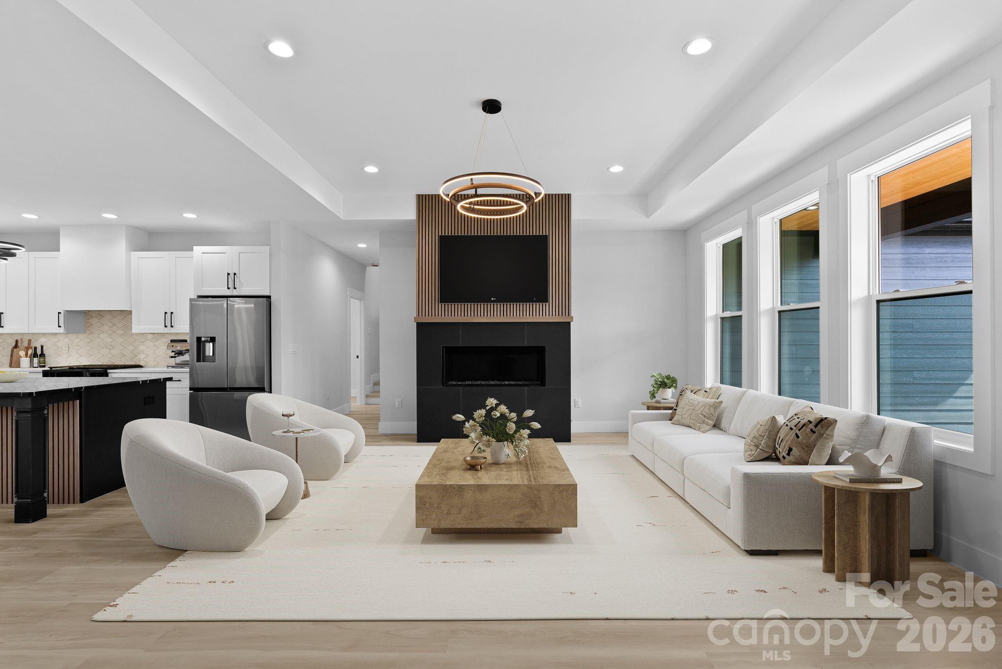19 East Starnes Cove Road Asheville, NC 28806 - Photo 4 of 46 a living room with furniture kitchen view and a fireplace