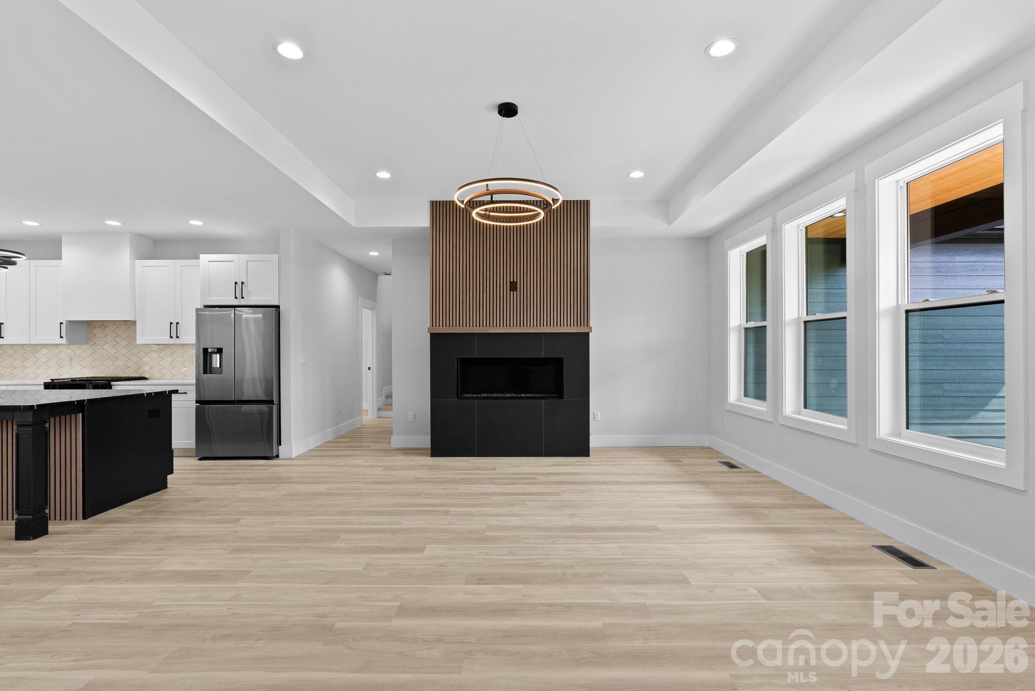 19 East Starnes Cove Road Asheville, NC 28806 - Photo 5 of 46 a view of an empty room with a kitchen