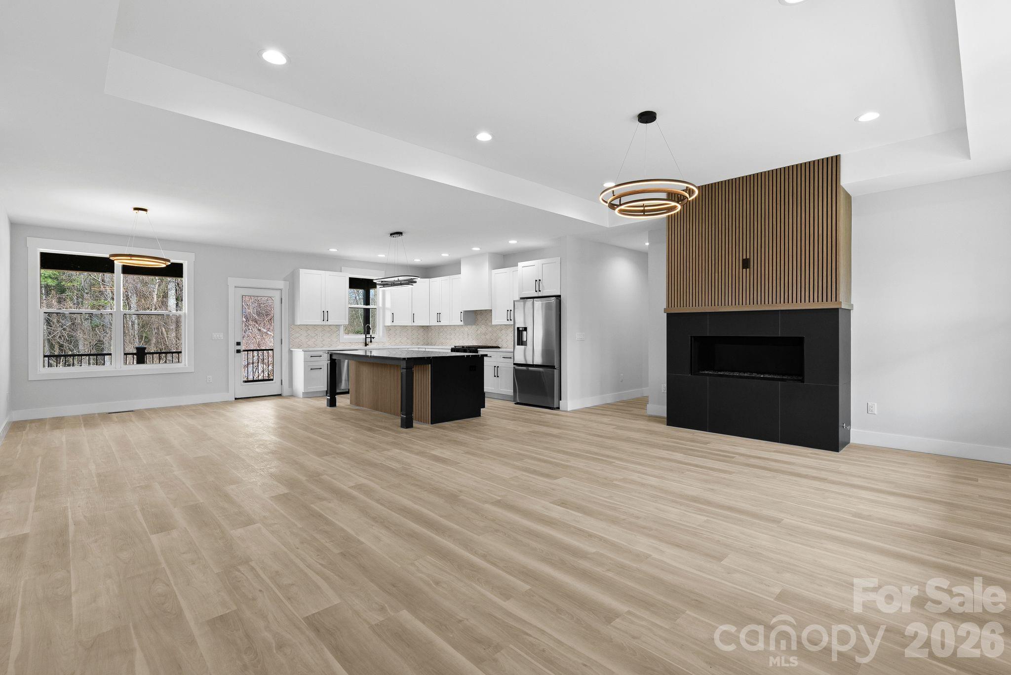 19 East Starnes Cove Road Asheville, NC 28806 - Photo 8 of 46 a view of an empty room with a window and fireplace