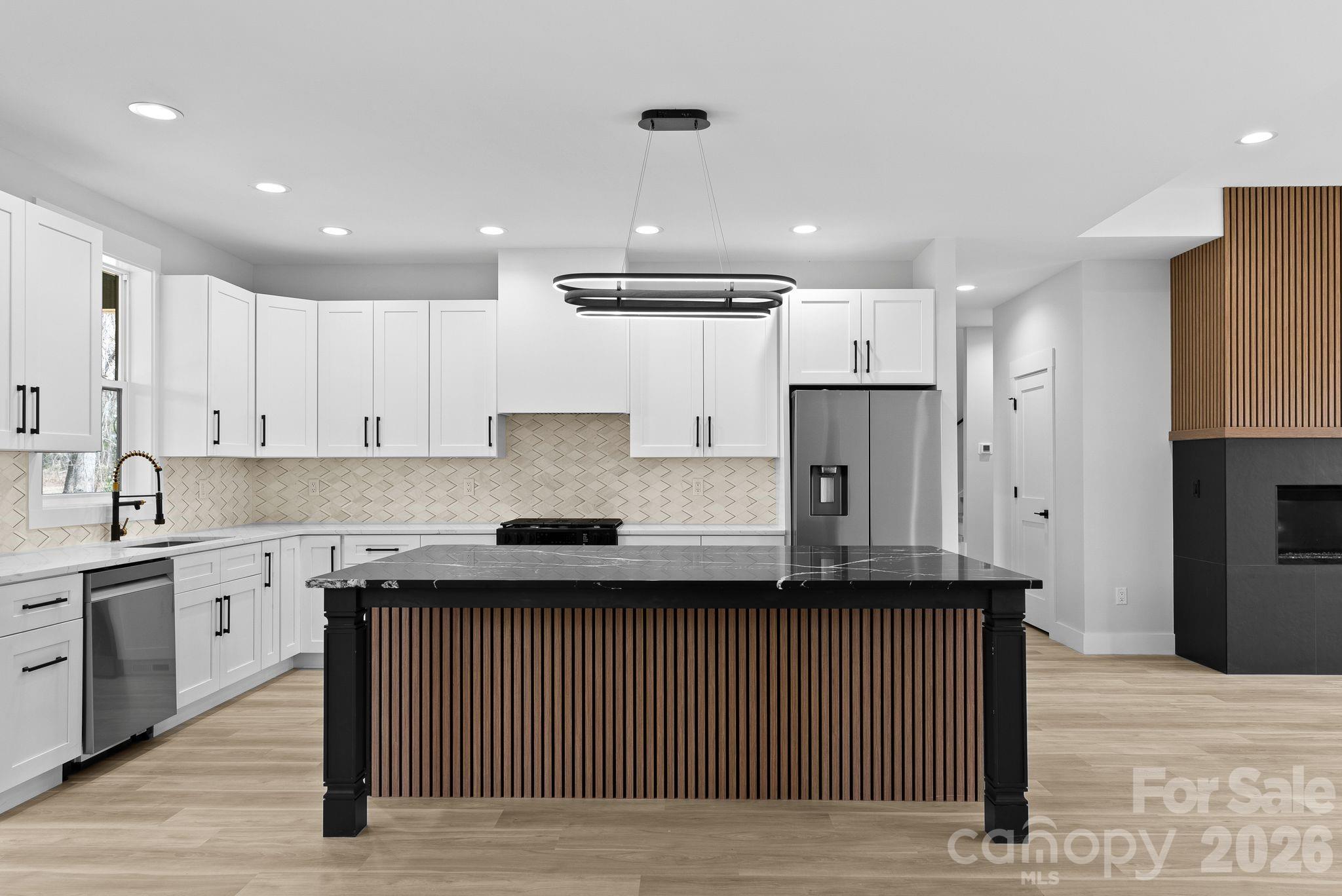 19 East Starnes Cove Road Asheville, NC 28806 - Photo 9 of 46 a kitchen with stainless steel appliances granite countertop a sink a stove and a refrigerator