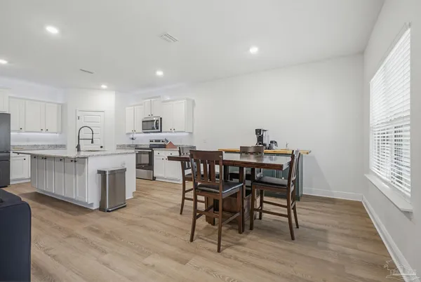 a view of a dining room with furniture and wooden floor