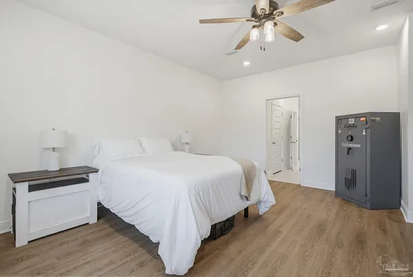 a bedroom with a bed and wooden floor