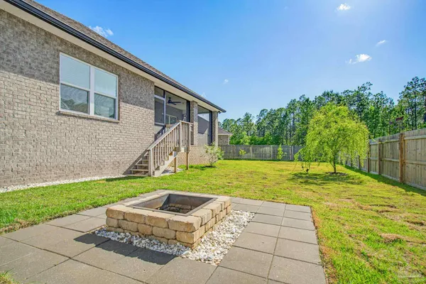 a backyard of a house with plants and wooden fence