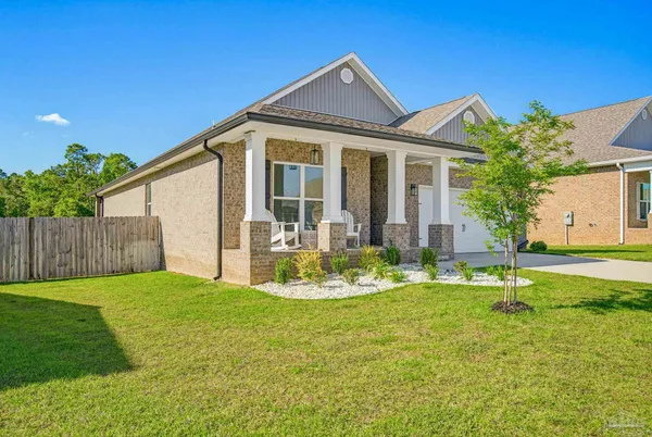a front view of house with yard and swimming pool