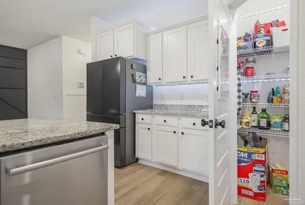 a kitchen with refrigerator and cabinets