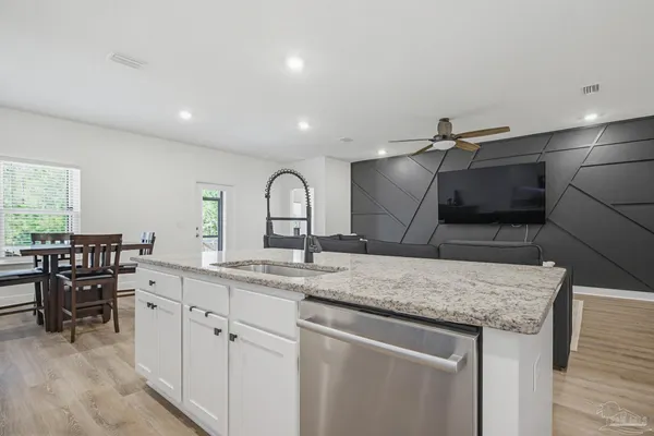 a kitchen with a sink and white cabinets