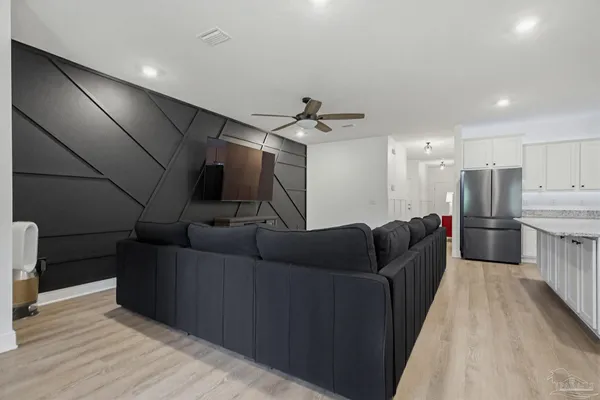 a living room with furniture and a wooden floor