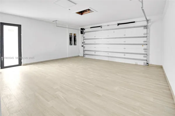 a kitchen with white cabinets and sink