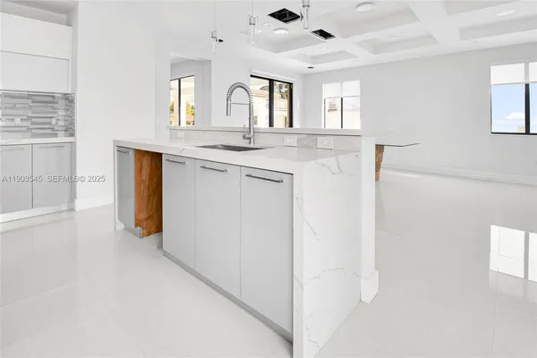 a view of a hallway with granite countertop cabinets