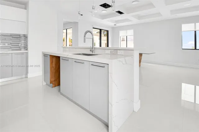 a view of a hallway with granite countertop cabinets