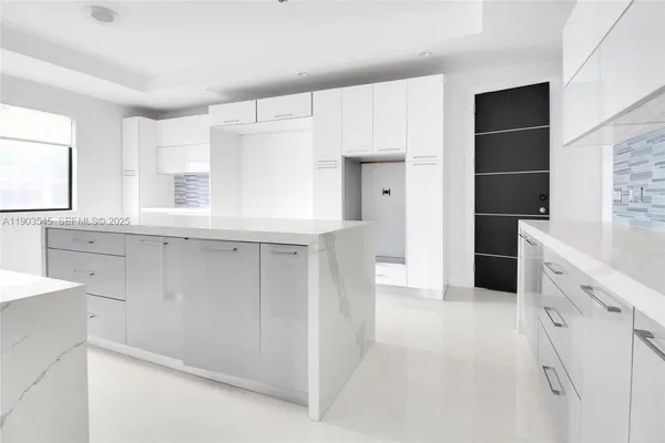 a hallway with cabinets and window