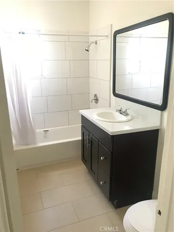 a bathroom with a sink vanity mirror and toilet