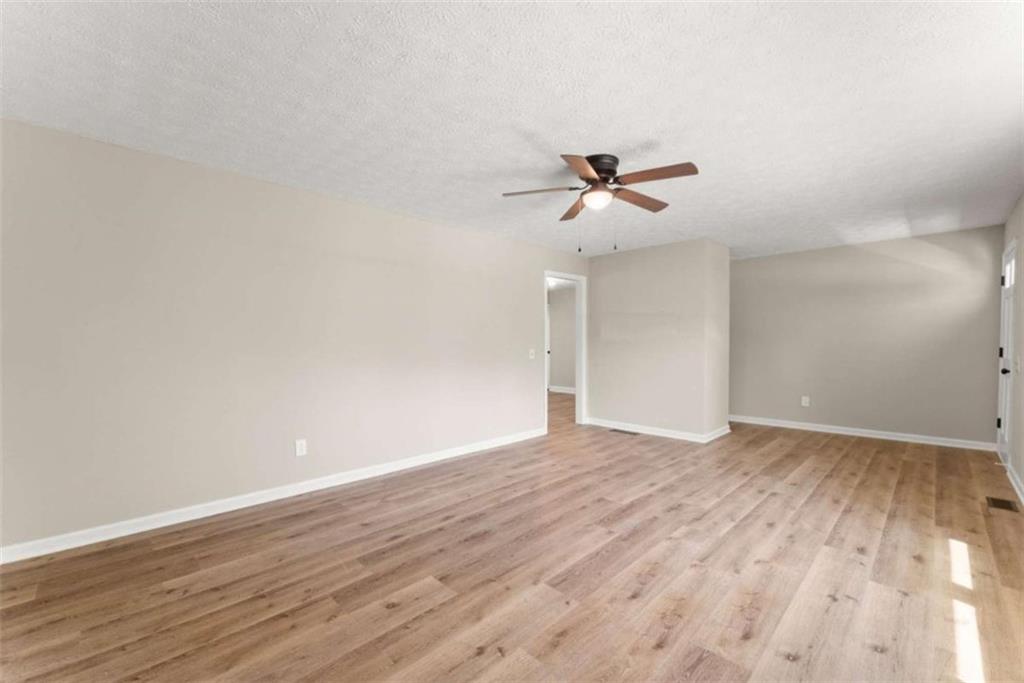 217 Quail Trail Cornelia, GA 30531 - Photo 11 of 48 a view of room with wooden floor and ceiling fan