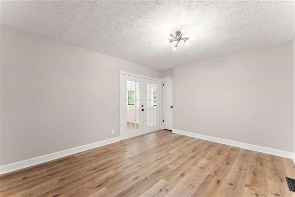 217 Quail Trail Cornelia, GA 30531 - Photo 13 of 48 a view of an empty room with wooden floor and a window