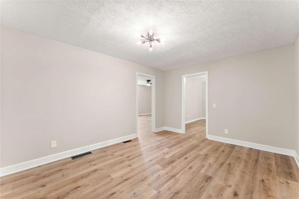 217 Quail Trail Cornelia, GA 30531 - Photo 14 of 48 a view of a room with wooden floor and a ceiling fan