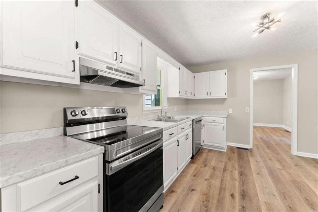 217 Quail Trail Cornelia, GA 30531 - Photo 20 of 48 a kitchen with stainless steel appliances granite countertop a stove and a sink