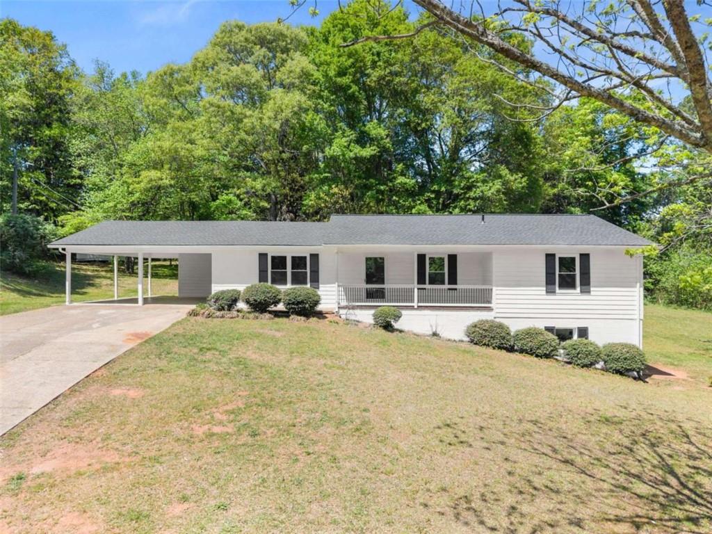 217 Quail Trail Cornelia, GA 30531 - Photo 2 of 48 a front view of house with yard and trees in the background