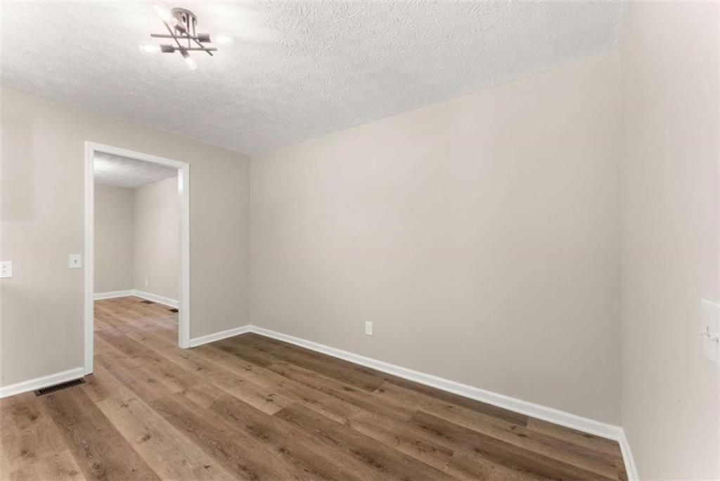 217 Quail Trail Cornelia, GA 30531 - Photo 21 of 48 a view of an empty room with wooden floor and a window