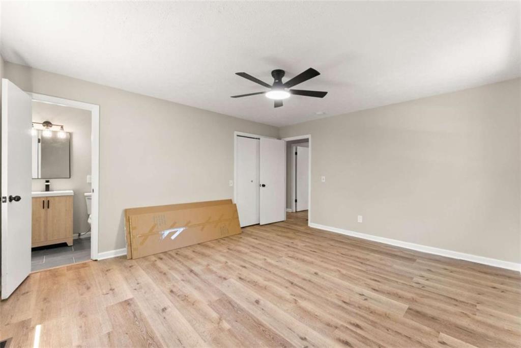 217 Quail Trail Cornelia, GA 30531 - Photo 29 of 48 a bedroom with a bed and a chandelier