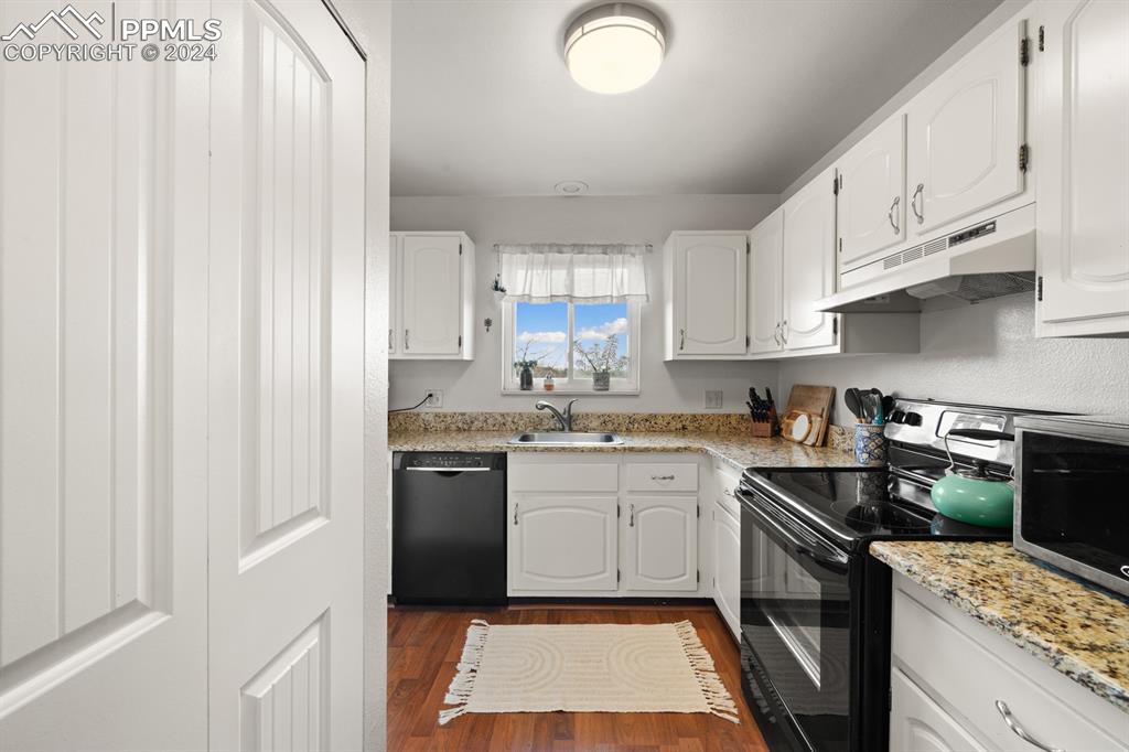 2949 Mesa Road, Unit C Colorado Springs, CO 80904 - Photo 11 of 28 a kitchen with a sink stove and refrigerator