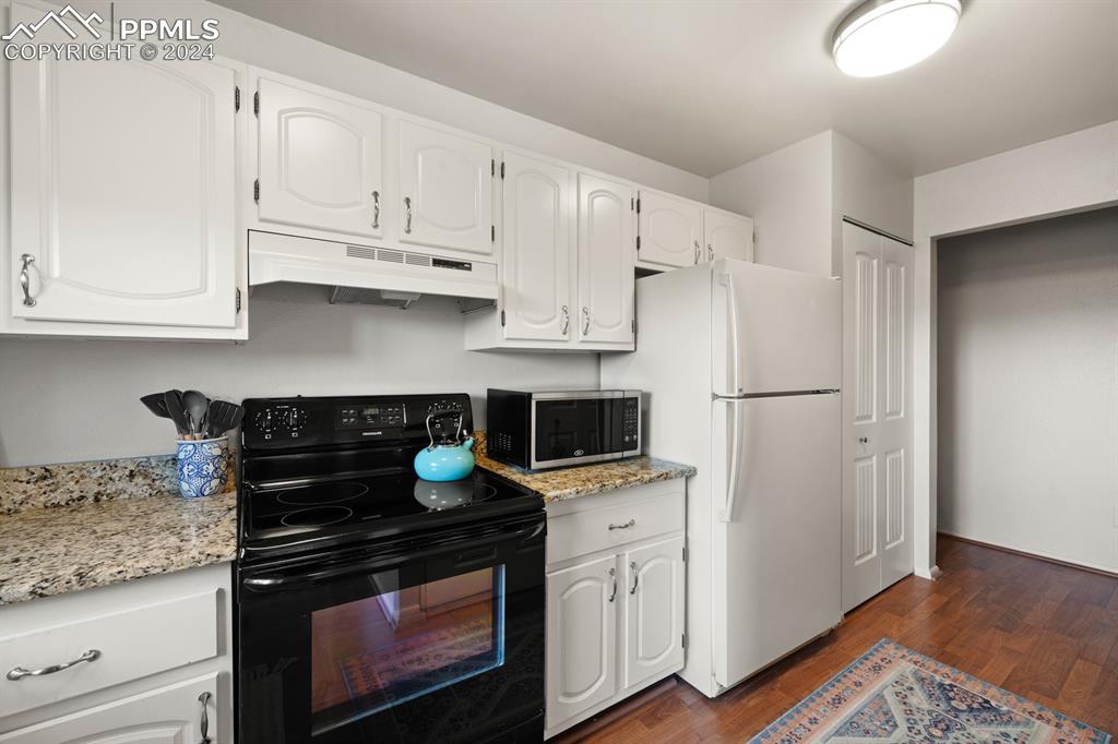 2949 Mesa Road, Unit C Colorado Springs, CO 80904 - Photo 12 of 28 a kitchen with white cabinets and appliances