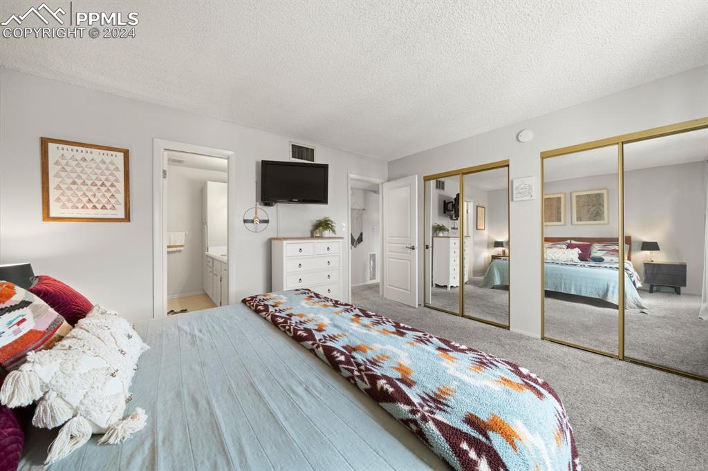 2949 Mesa Road, Unit C Colorado Springs, CO 80904 - Photo 18 of 28 a bedroom with a bed and a flat screen tv