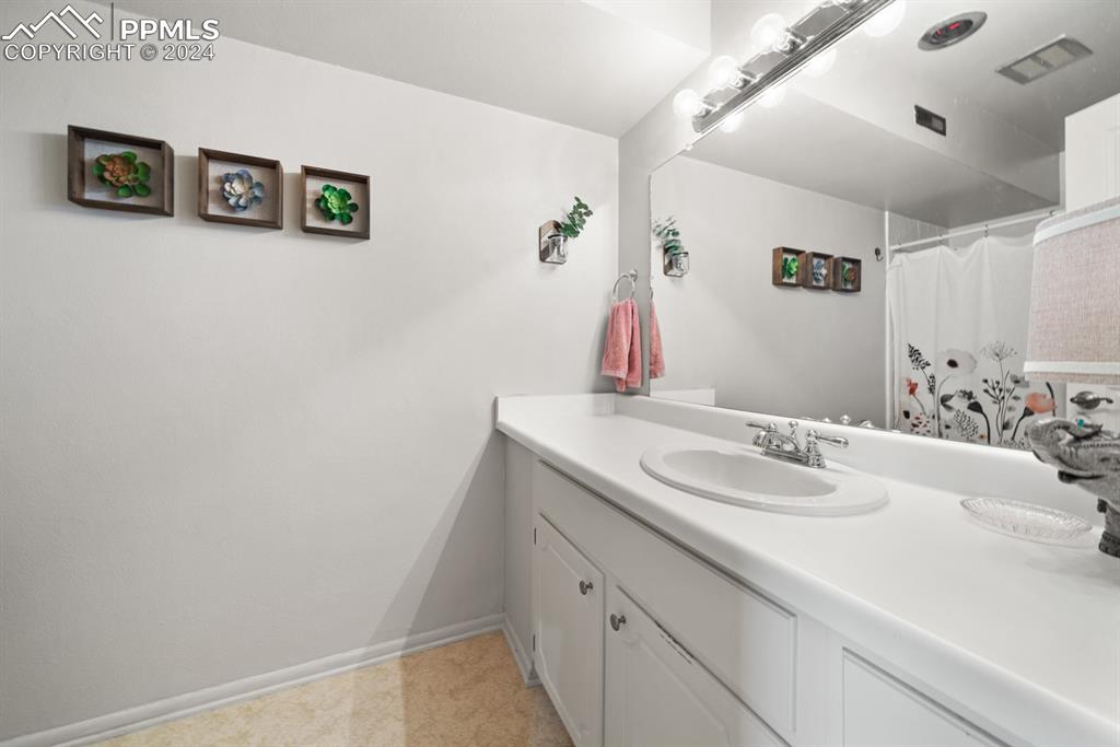 2949 Mesa Road, Unit C Colorado Springs, CO 80904 - Photo 23 of 28 a bathroom with a sink and a mirror