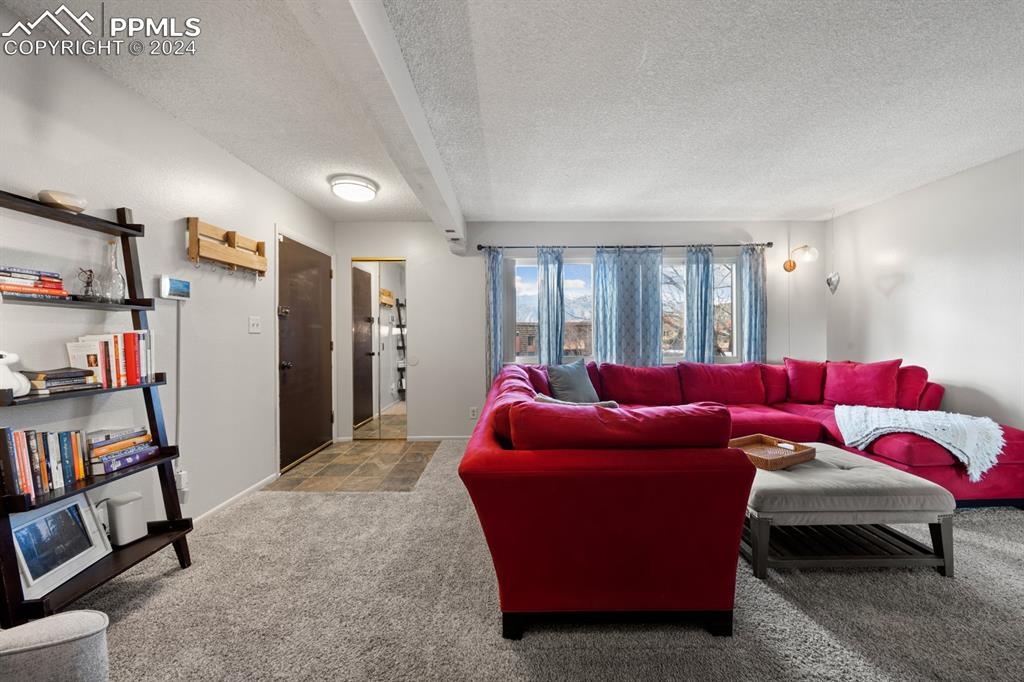 2949 Mesa Road, Unit C Colorado Springs, CO 80904 - Photo 4 of 28 a living room with furniture and a book shelf