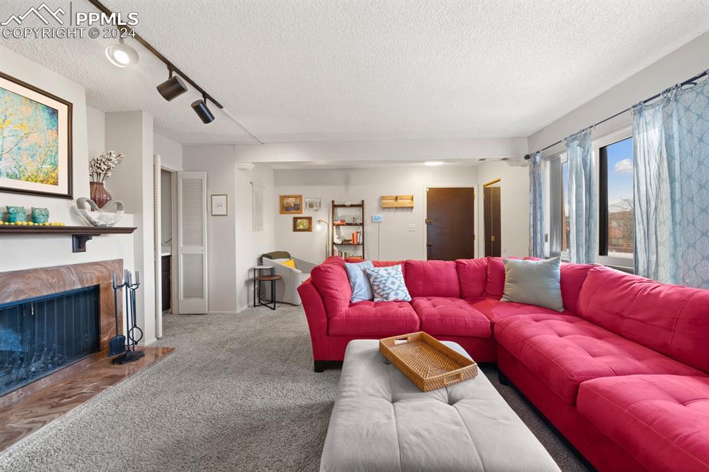 2949 Mesa Road, Unit C Colorado Springs, CO 80904 - Photo 5 of 28 a living room with furniture and a fireplace