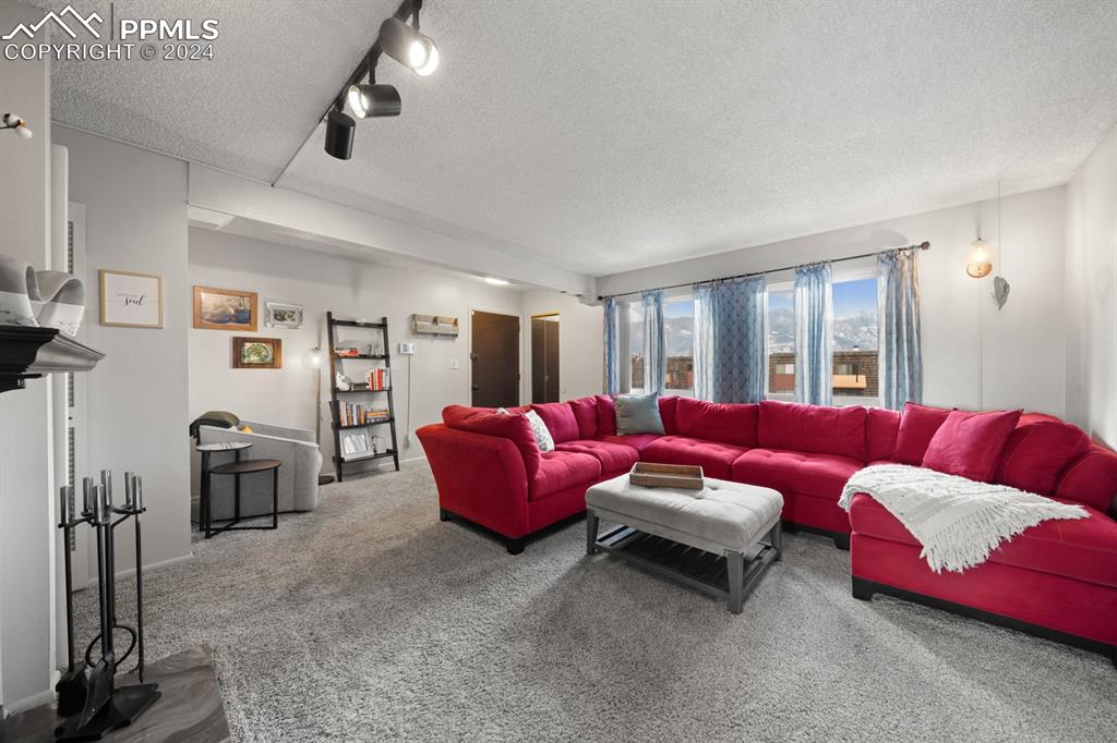 2949 Mesa Road, Unit C Colorado Springs, CO 80904 - Photo 6 of 28 a living room with furniture and a flat screen tv