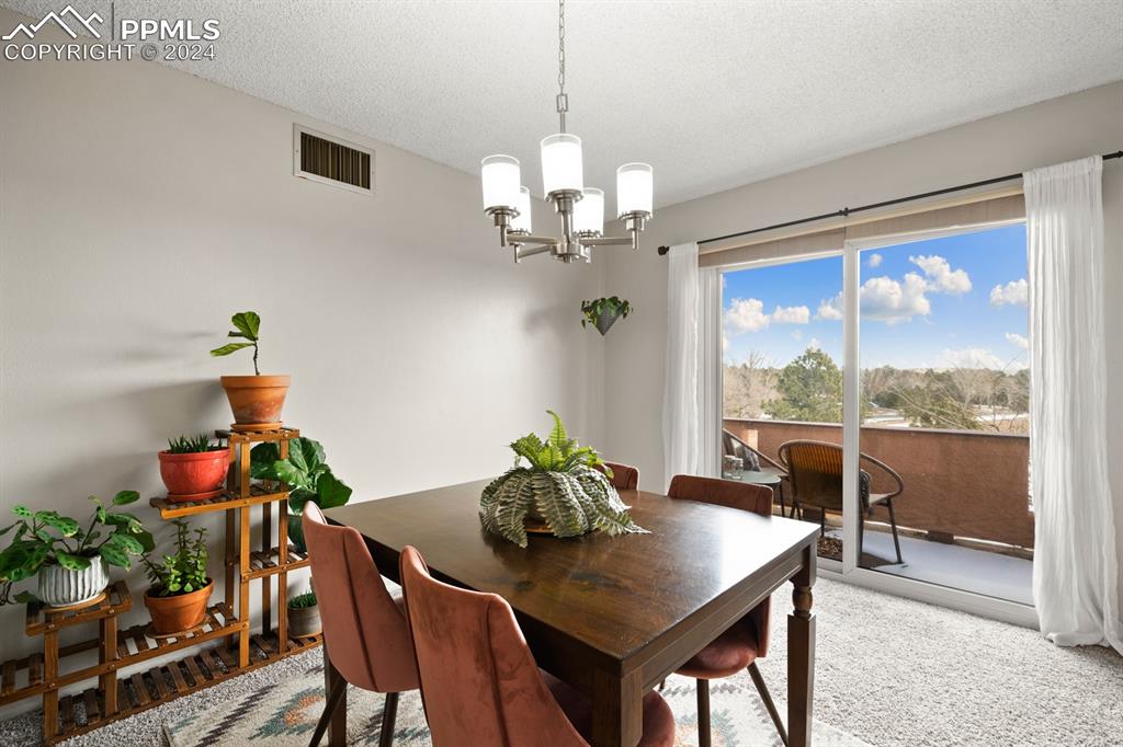 2949 Mesa Road, Unit C Colorado Springs, CO 80904 - Photo 8 of 28 a view of a dining room with furniture window and wooden floor