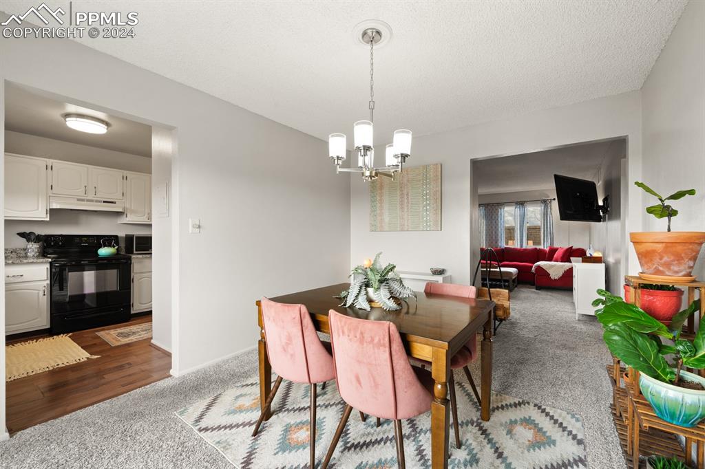 2949 Mesa Road, Unit C Colorado Springs, CO 80904 - Photo 9 of 28 a view of a dining room with furniture and chandelier