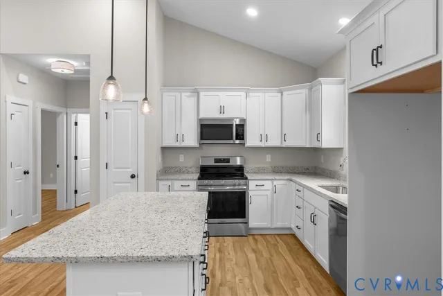 a kitchen with stainless steel appliances granite countertop a refrigerator and a sink