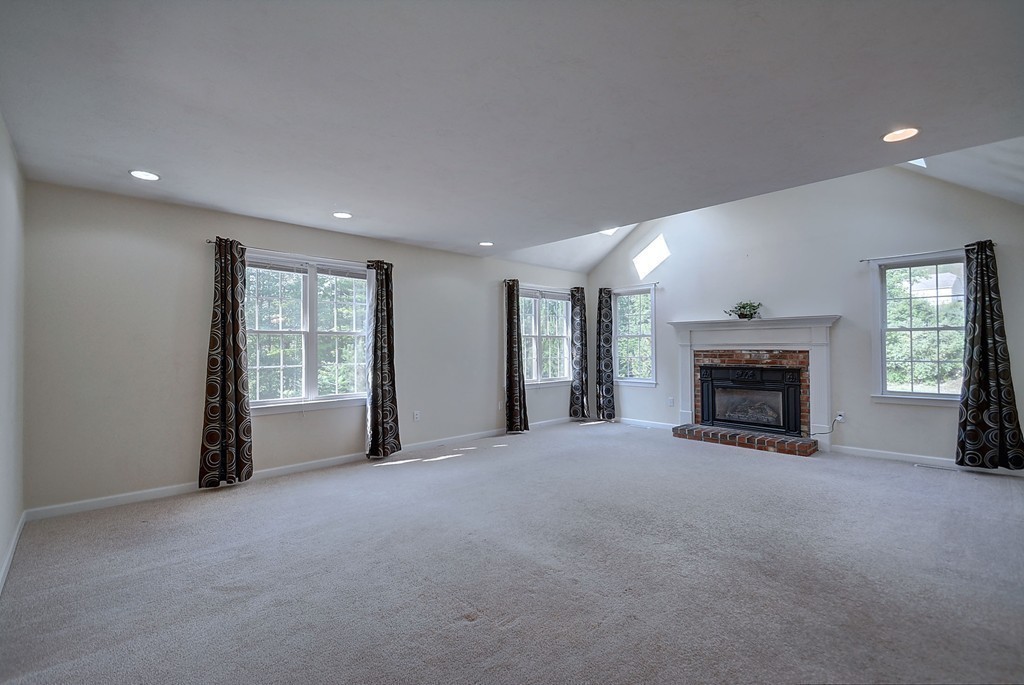 67 Arnold Road Sturbridge, MA 01518 - Photo 11 of 29 a view of an empty room with a fireplace and a window